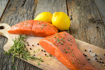 Salmon on a Cutting Board with Lemon, Salt and Pepper
