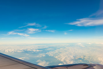Fototapeta na wymiar Clouds and sky as seen through window of an airplane