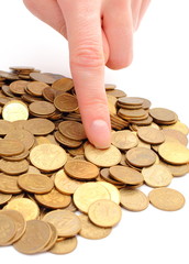 Heap of old coins and finger of woman