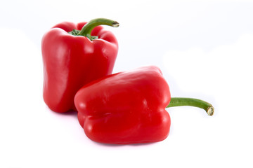 Two isolated red peppers