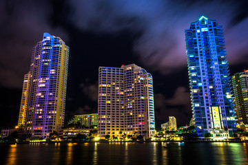 Fototapeta na wymiar Skyscrapers along the Miami River at night, in downtown Miami, F