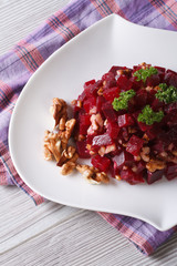 Beet salad with walnuts close-up  vertical top view