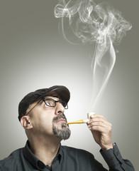 Fototapeta premium The man smokes a pipe
