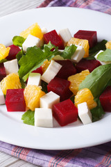Fresh beet salad with oranges, cheese and arugula, vertical