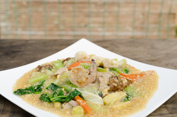 Fried noodle with pork and kale soaked in gravy