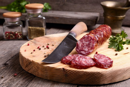 Salami and knife on a cutting board