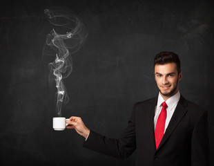 Businessman holding a white steamy cup