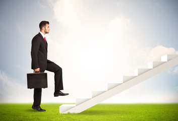 Business person climbing up on white staircase in nature