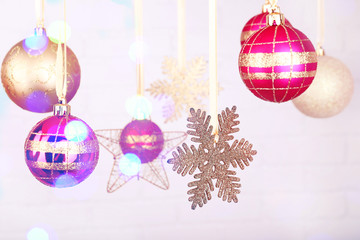 Christmas decorations hanging on festive background