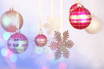 Christmas decorations hanging on festive background