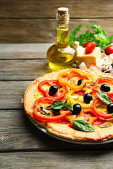 Delicious pizza served on wooden table