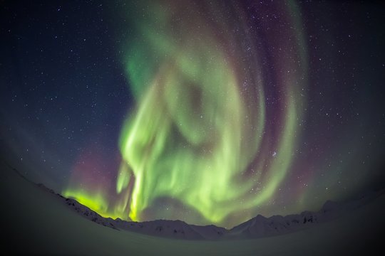 Beautiful Northern Lights over the Arctic mountains and glaciers