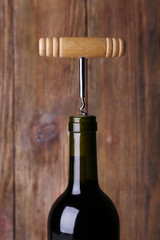 Bottle opener close-up, on wooden background