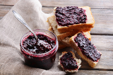 Delicious black currant jam on table close-up