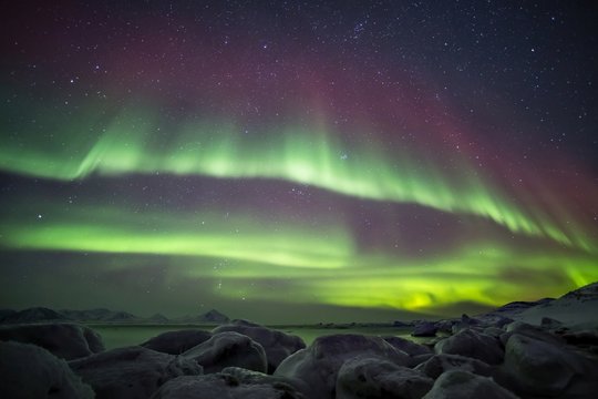 Beautiful Northern Lights over the Arctic frozen fjord