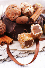Pile of chunk of chocolate and truffles with cinnamon stick