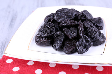 Squared white plate of prunes