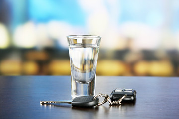 Glass of alcoholic drink and car key,