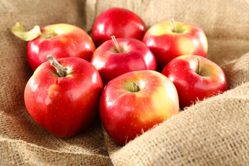 Heap of apples in burlap cloth background