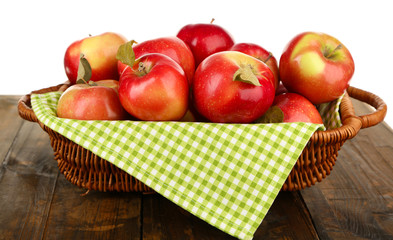 Naklejka na ściany i meble Wicker basket of red apples with napkin