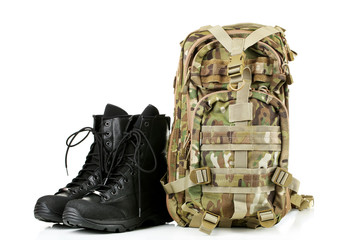 Black army boots and backpack, isolated on white