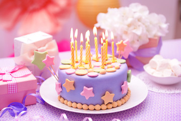 Delicious birthday cake on table on bright background