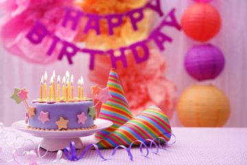 Delicious birthday cake on table on bright background