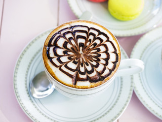 cappuccino coffee in white cup on wooden table