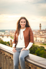 Beautiful girl impressed view the panorama of Florence in autumn