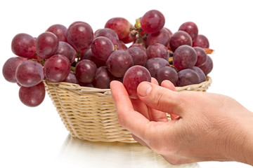 Large red grapes and hand