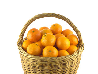 Tangerines in brown wicker basket isolated on white