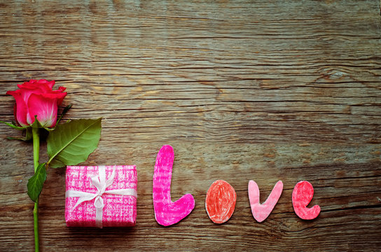 Valentine's background with gift, flower and word Love