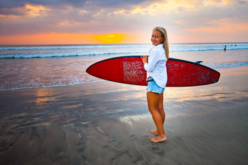 young girl with surfboard at the beach