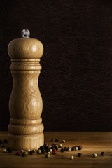 Wooden pepper mill grinder and peppercorns with copy space