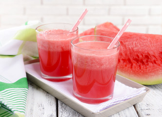 Juicy watermelon on table on brick wall background