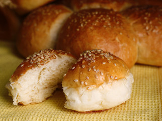 Tasty buns with sesame on napkin  background