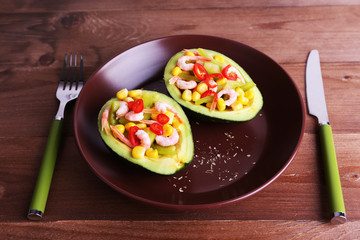 Tasty salad in avocado on plate table close-up