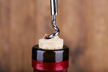 Bottle opener close-up, on wooden background