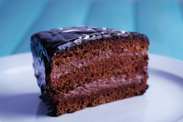 Delicious chocolate cake on plate on table close-up