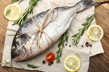 Fresh raw fish and food ingredients on table