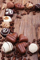 Frame of different chocolates with coffee beans