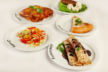 Daily menu. Plates with food on table