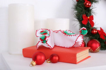 Christmas decorations on mantelpiece on white wall background