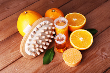 Obraz na płótnie Canvas Ripe orange with bottles of bath salt and essential oil, bar of