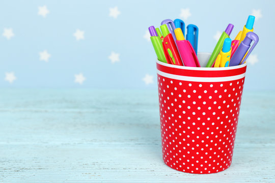 Plastic cup with different pens
