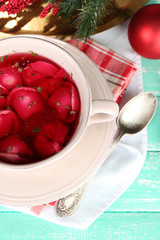 Traditional polish clear red borscht with dumplings and