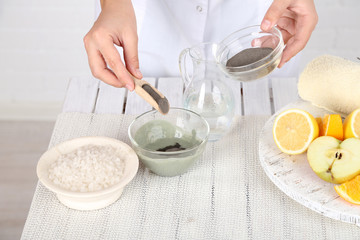 Beautician makes cosmetic facial masks, close-up