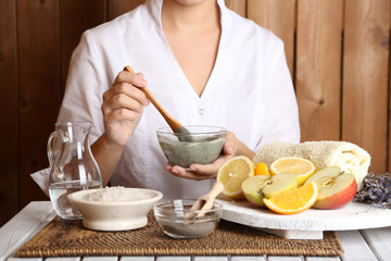 Beautician makes cosmetic facial masks, close-up,
