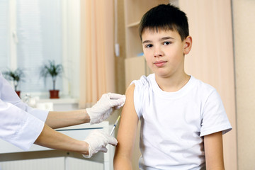 Obraz na płótnie Canvas Boy and vaccine syringe
