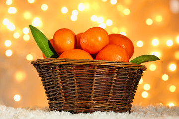 Fresh ripe mandarins in wicker basket,
